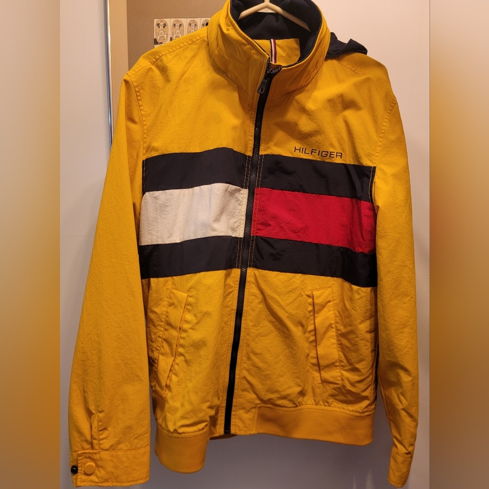 Tommy Hilfiger Yellow Windbreaker with Red, Black, and White Stripes.